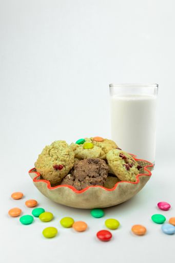 A vertical shot of tasty cookies with colorful candies in  a plate