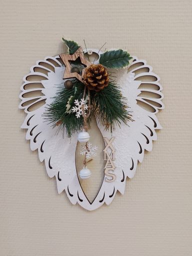 A vertical closeup shot of a Christmas decoration hanging from a wall