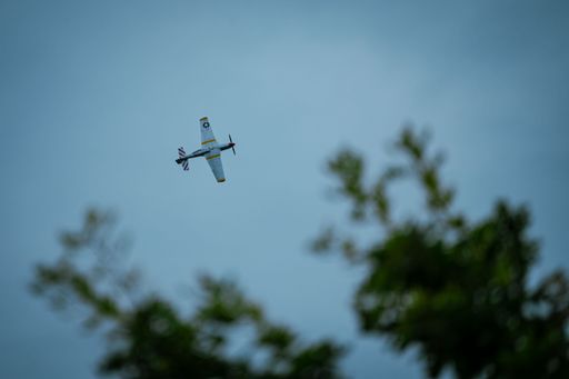 A P-51 American Mustang Propeller plane flying on a blue sky background