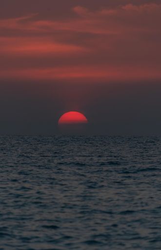 An aerial view of sea during sunset