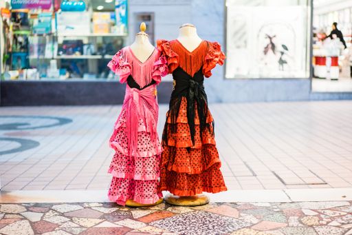 A closeup shot of Spanish flamenco dresses at an outdoor market