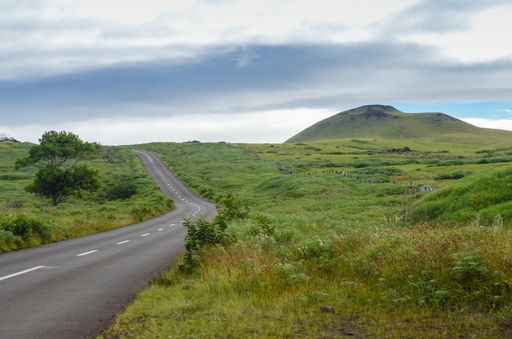 A road that turns to the right without any cars and some hills on the background in Uruguay, next to Tacuarembo.