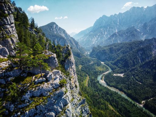 An aerial view of Enns river and lush green vegetation of Gesause National Park in Austria