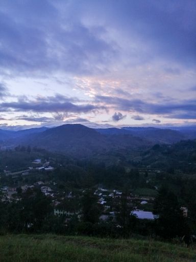 A beautiful shot of clouds above grassy hills in the morning