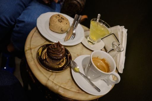 A high angle shot of a comforting coffee table with delicious desserts