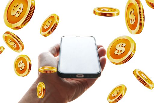 A man's hand holding smartphone with flying golden dollar coins - online banking concept