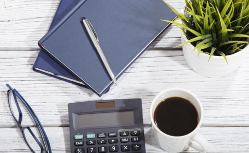 A mix of office supplies and gadgets on a wooden table