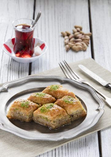 A vertical shot of Turkish Ramadan dessert baklava on a wooden table