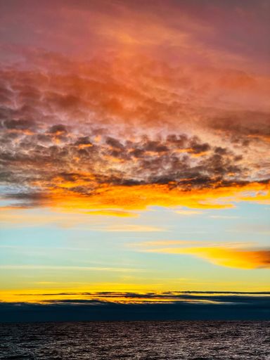 Charming scenery with colorful sunset sky over peaceful ocean