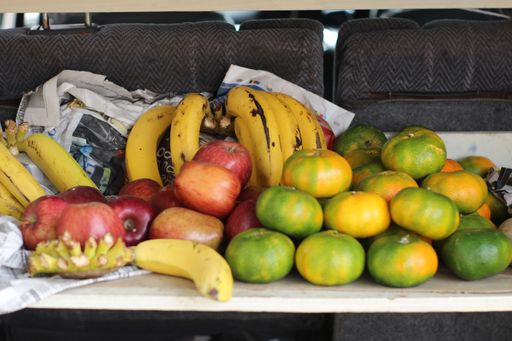 A closeup shot of fresh fruits on a table with newspapers