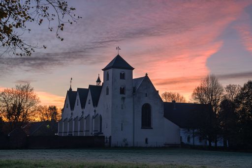 A closeup shot of the Dunnwald Church with the beautiful sunset in the background in Germany