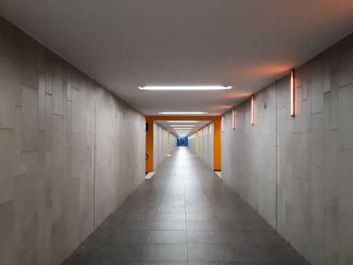 A long empty hallway with led lights on the wall