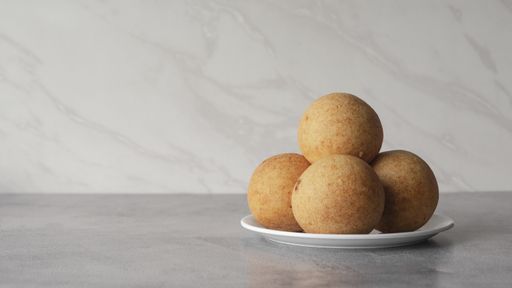 A closeup shot of traditional Columbian Bunuelo cheese balls one on another before the Christmas dinner