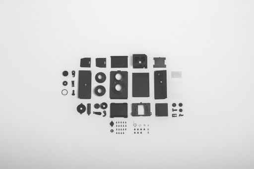 A top view shot of twin-lens vintage open camera kit pieces isolated on a white background