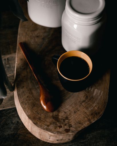 A vertical shot of a coffee cup on a wooden table