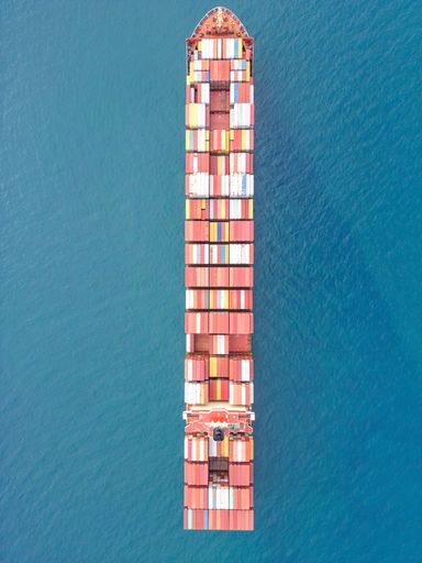 An aerial view of cargo ship sailing in sea