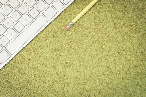 A top view of a computer keyboard on an office desk and pencil with copy space