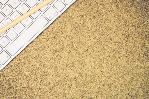 A top view of a computer keyboard on an office desk and pencil with copy space