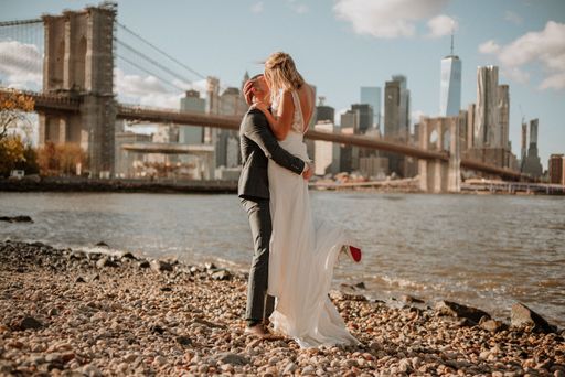 A beautiful shot of a couple hugging each other by the New York skyscrapers