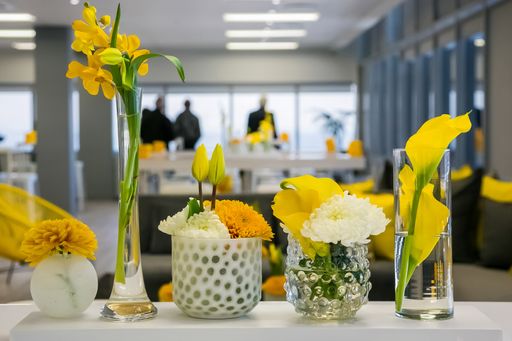 Various types of yellow and white flowers on a table for venue decoration