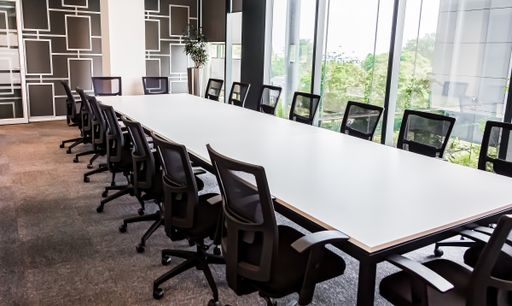 A long office table with a lot of chairs