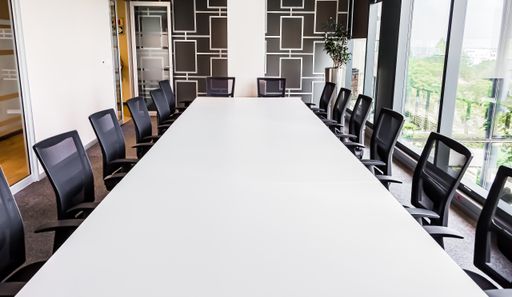 A long office table with a lot of chairs
