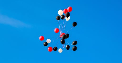 A low angle shot of flying balloons