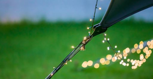 A closeup shot of bokeh fairy lights on a string hanging from an outdoor Bedouin tent