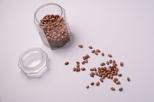 A high angle shot of beans in a storage jar