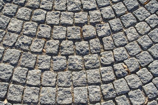 An overhead shot of old cobblestone pavement in circular pattern
