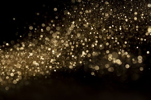 A closeup shot of beautiful golden glitter for wallpaper or background