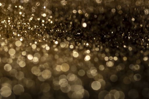 The shiny golden bokeh lights on a black background