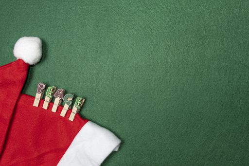 A top view Santa Claus hat with clips word peace on green background