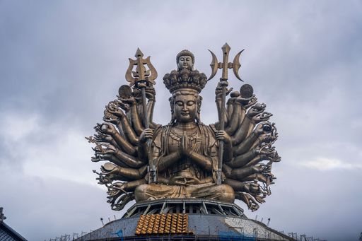 a statue of buddha with multiple hands