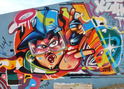 A mural of an abstract graffiti on a historic wall in Lisbon, Portugal