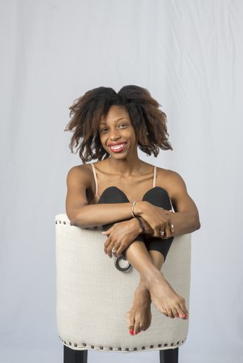 A vertical shot of a beautiful dancer lady posing on a white background