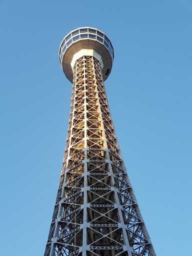 A vertical low angle shot of a tower on the background of the blue sky