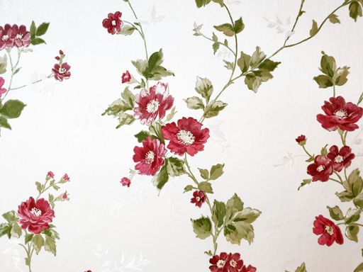 A closeup of wallpaper with flower and vines design
