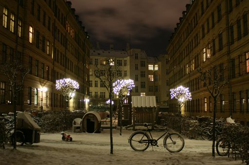 A beautiful view of Copenhagen, Denmark at night in the winter with city lights under a foggy sky
