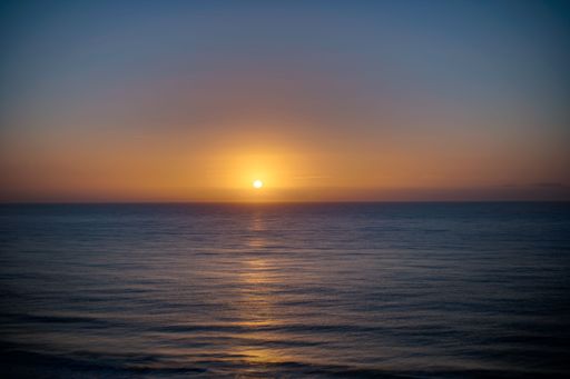 A beautiful shot of a bright sunset sky over the blue sea
