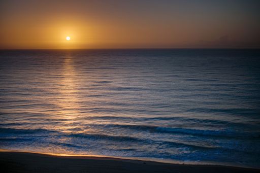 A beautiful shot of a bright sunset sky over the blue sea