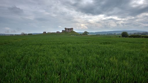 The Duffus Castle on the Laich of Moray with a cloudy sky in the background, Scotland
