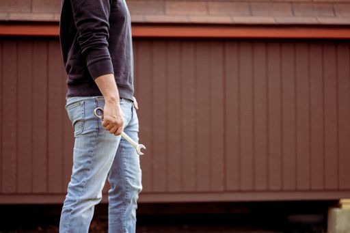 A closeup shot of a male holding a tool in his hand