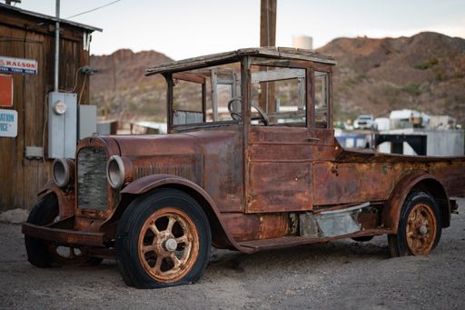 An old rusty historic Studebaker car abandoned in a Wild West town