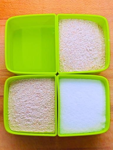 A top view of sugar and flour in small green plastic containers on the table