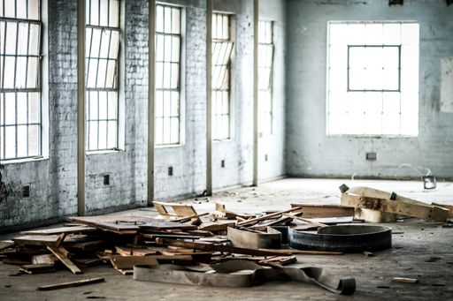 The interi of an abandoned warehouse with scattered wood planks