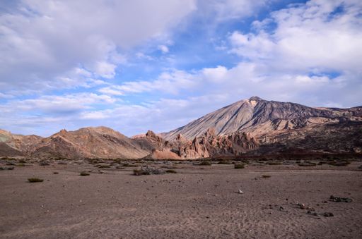 A mesmerizing shot of a beautiful mountainous landscape under a blue and cloudy sky