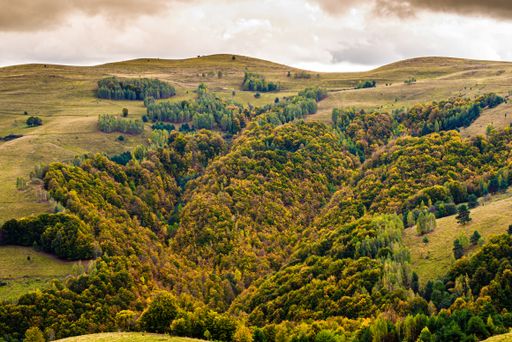 A beautiful landscape with the famous Apuseni Mountains range in Romania under a cloudy sky