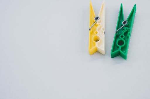 A top view of plastic clothespins isolated on white background