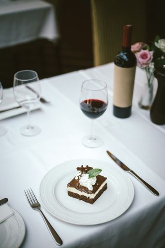 A selective focus shot of a delicious brownie with red wine in a restaurant